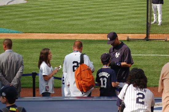 Jeter signs for YSL contest winners including Madeleine Baxter, left, and Josh Adams (with backpack).