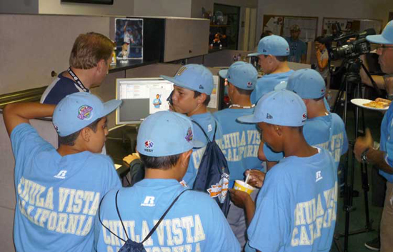 Computer Savvy: Several of the Park View All-Stars crowd around art designer Richard Gassman’s cubicle inside Upper Deck’s Prepress department to see their cards come to life.