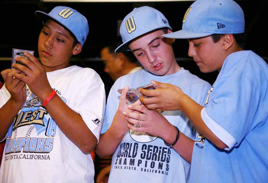 CHECK THIS OUT: Teammates Andy Rios, Seth Godfrey and Daniel Borras Jr. admire each other’s cards.